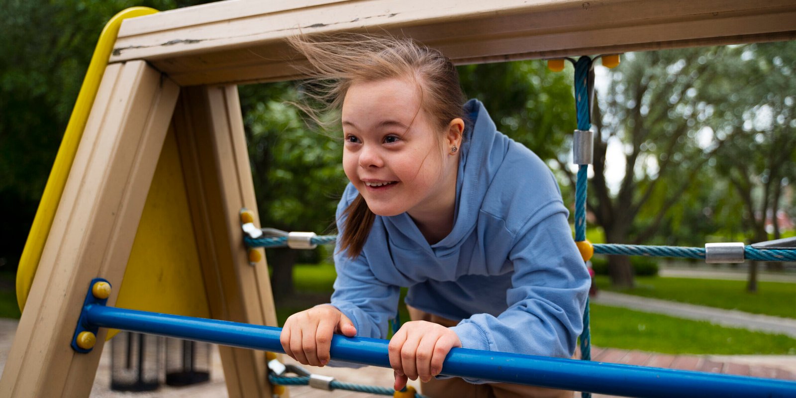 happy-child-with-down-syndrome-playing-outside